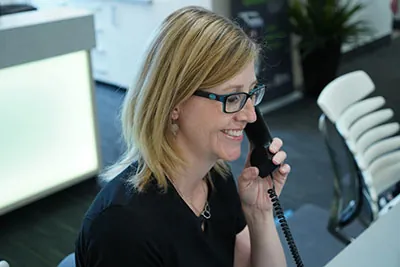 Jacquie from Strathcona Dental Clinic talking with a patient