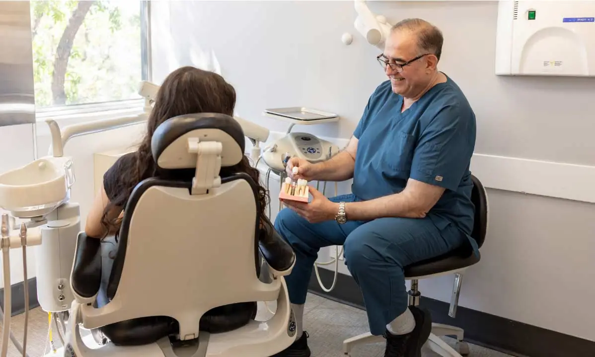 Dr. Abdul Wehbe showing a patient how dental implants work
